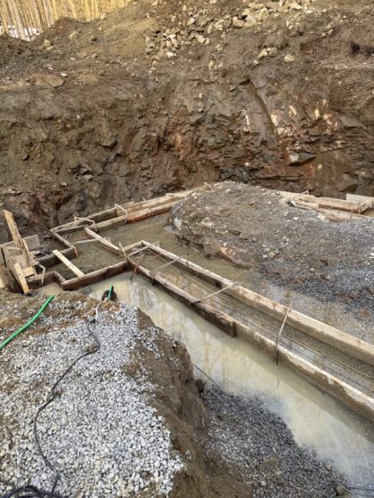 Coffrage de semelles de fondation en bois installé au fond d'une excavation creusée dans le roc